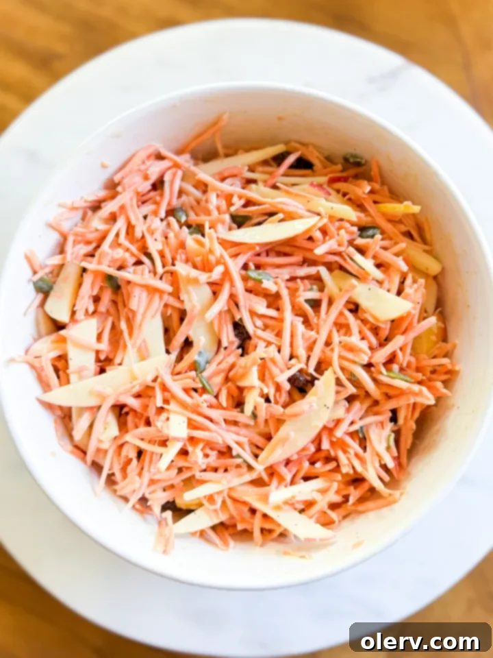 Vibrant Carrot Slaw 6 Carrot Slaw Salad served in a bowl with a fork, ready to eat.