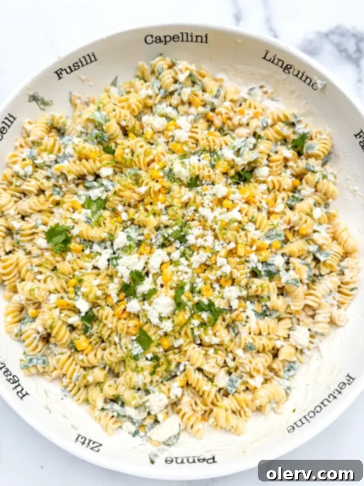 Creamy Street Corn Pasta Salad 2 A close-up shot of a vibrant Street Corn Pasta Salad in a large bowl, garnished with fresh cilantro.