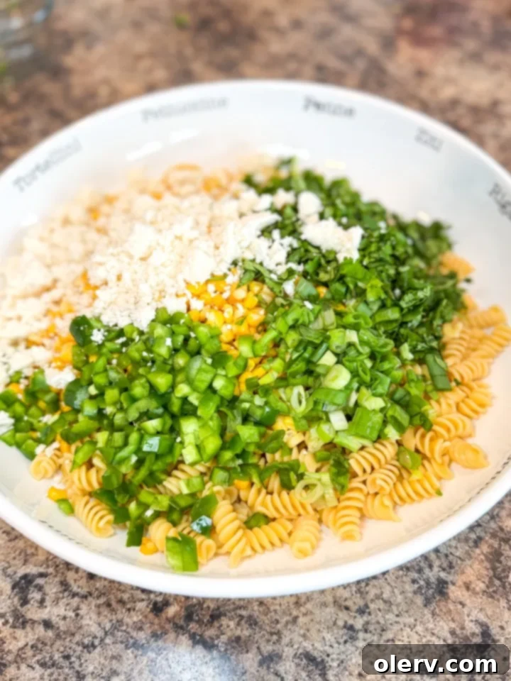 Creamy Street Corn Pasta Salad 4 A bowl of creamy lime dressing for the Street Corn Pasta Salad, showcasing its smooth texture.