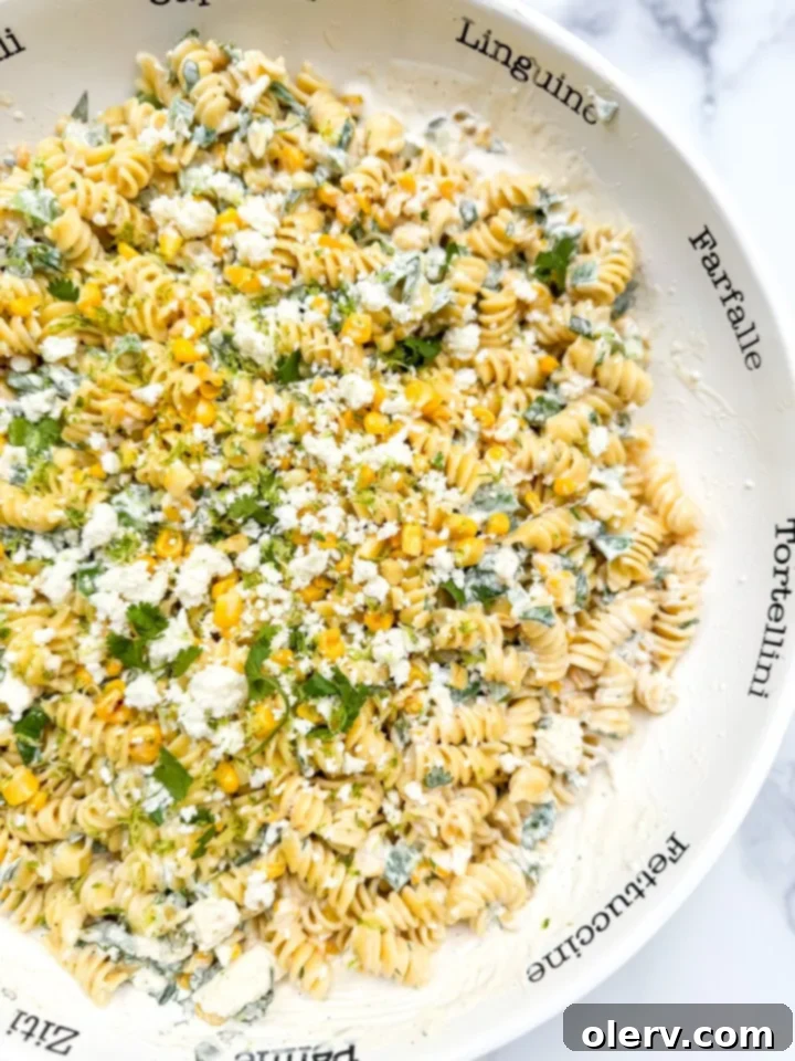 Creamy Street Corn Pasta Salad 6 A large serving bowl of Street Corn Pasta Salad, perfectly tossed and garnished, ready to be enjoyed.