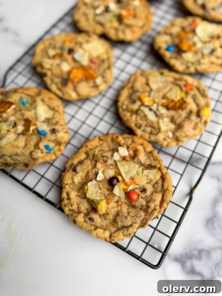 Pantry Raid Cookies 5 Freshly baked Kitchen Sink Cookies cooling on a wire rack, still warm and inviting.