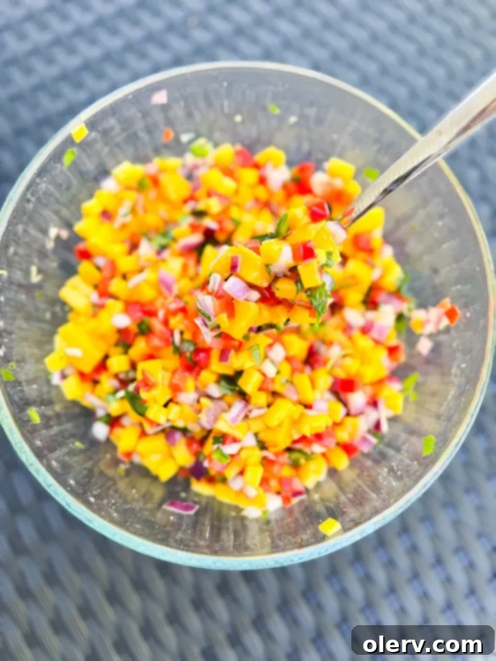 A bowl of fresh mango salsa ready to be served