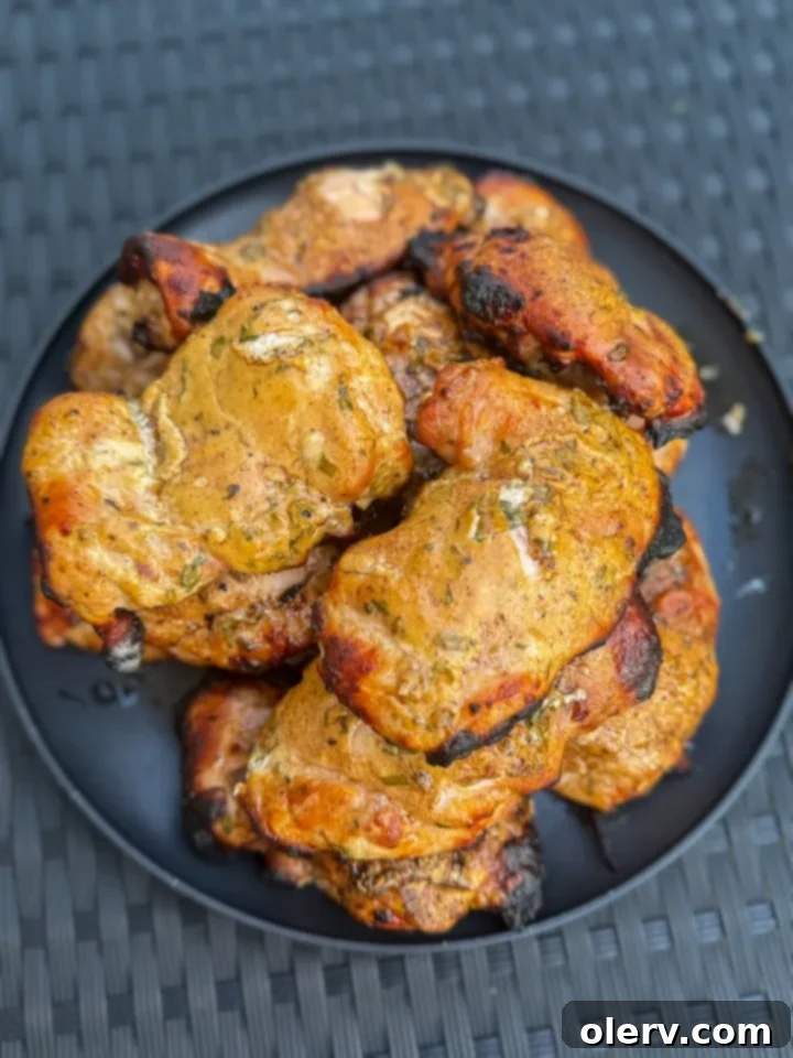 Zesty Greek Grilled Chicken Made Easy 2 Beautifully marinated raw chicken pieces ready for grilling, showcasing the creamy Greek yogurt marinade