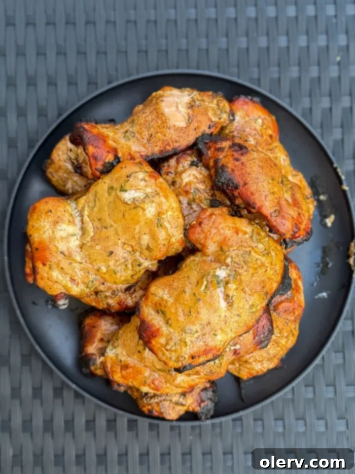 Zesty Greek Grilled Chicken Made Easy 5 Perfectly grilled Greek chicken on a cutting board, ready to be sliced
