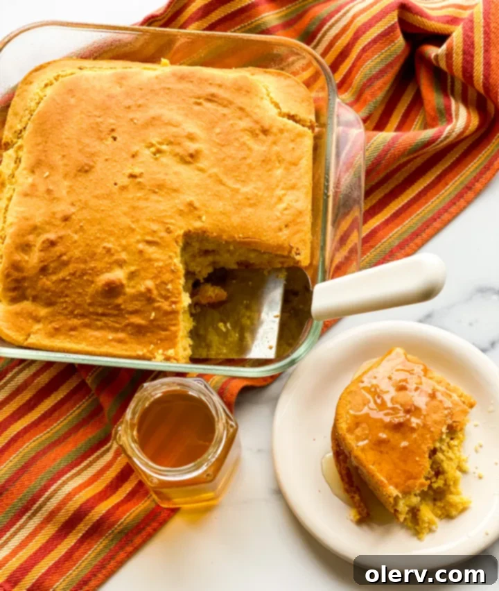 The Ultimate Cornbread 5 Buttermilk, an essential ingredient for fluffy and moist cornbread, in a measuring cup