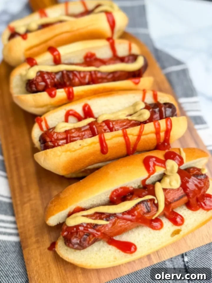 Crispy Air Fryer Hot Dogs 2 Perfectly cooked hot dogs in an air fryer basket, ready to be served.