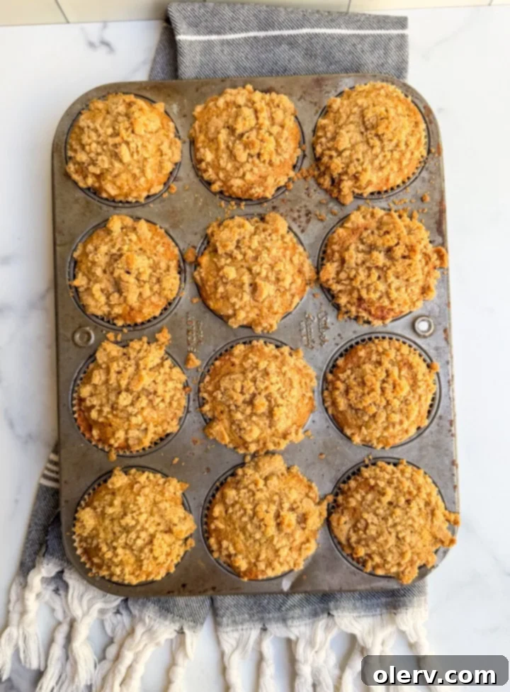 A trio of delicious banana bread muffins with streusel topping, perfectly baked and ready to be enjoyed.