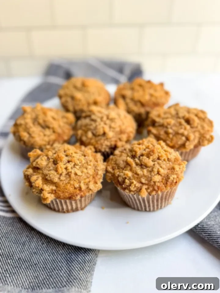 A beautiful arrangement of various baked goods, including more streusel-topped banana muffins, inviting readers to explore other recipes.