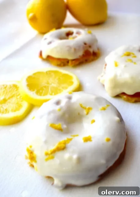 Protein-Packed Lemon Donuts 3 A stack of lemon protein donuts with a light glaze and lemon zest.