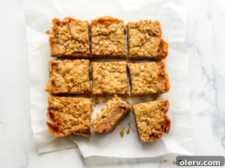 Unforgettable Carmelita Bars 4 A tray of freshly baked Carmelitas, still warm, with visible caramel and chocolate oozing slightly.