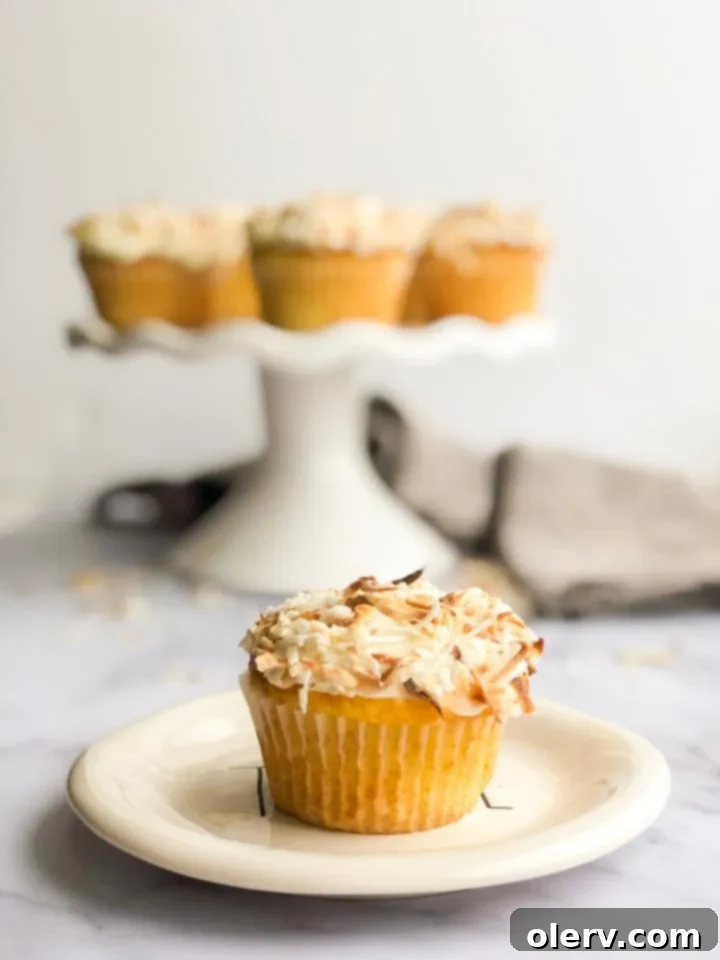 Triple Coconut Dream Cupcakes 4 Array of coconut cupcakes, showcasing the beautiful frosting and toasted coconut