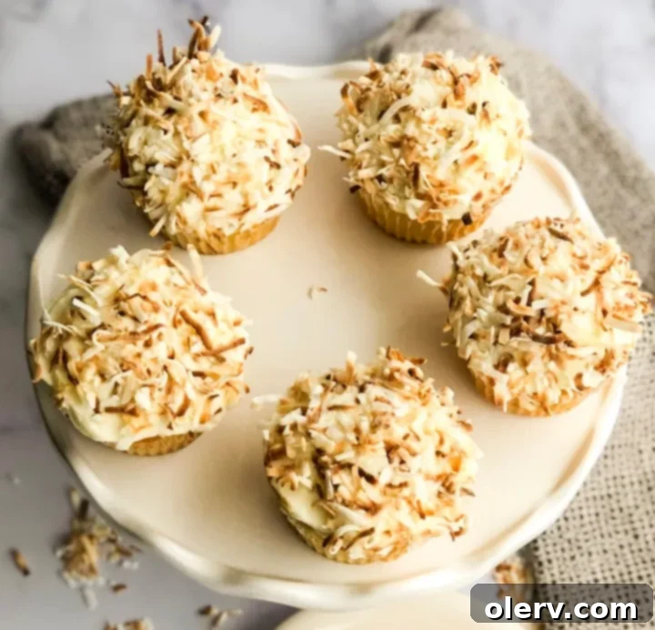 Triple Coconut Dream Cupcakes 5 Closer shot of a coconut cupcake, showing the texture of the cake
