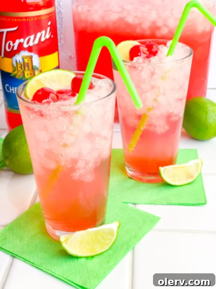 Crimson Zest Sparkle 7 Sparkling Cherry Limeade in a Mason jar glass, perfect for game day tailgating