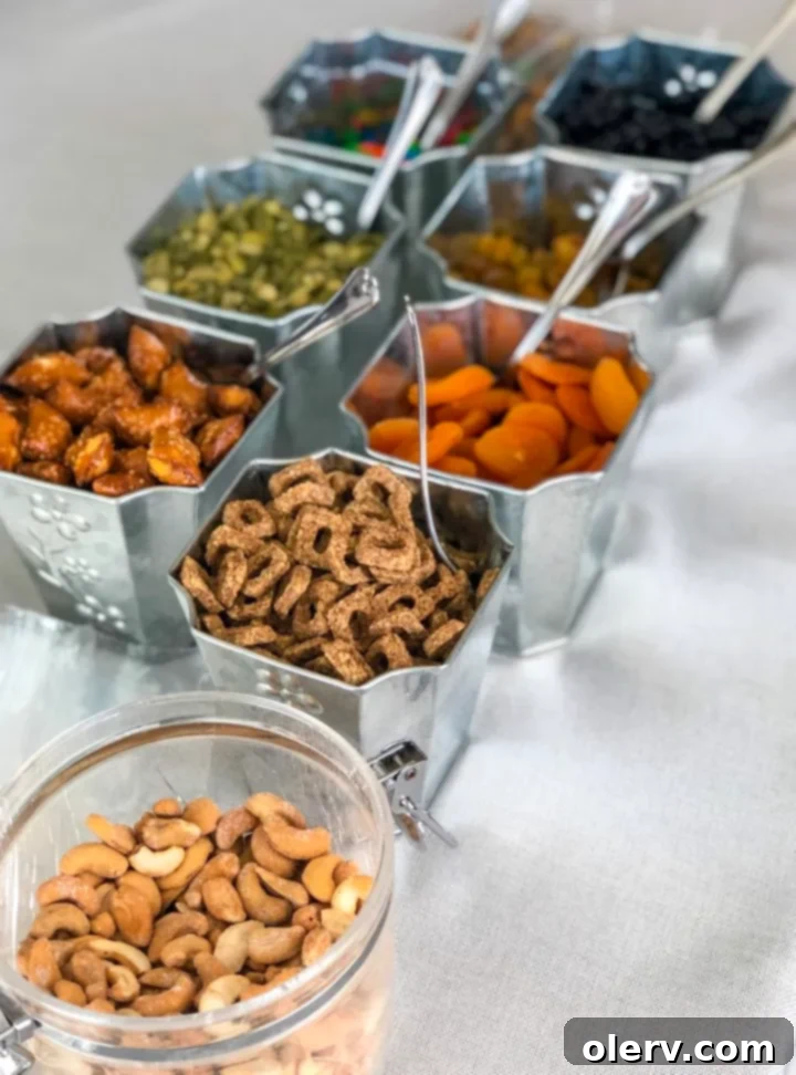 Craft Your Own Trail Mix 3 Variety of trail mix ingredients including nuts, seeds, and dried fruit in separate bowls