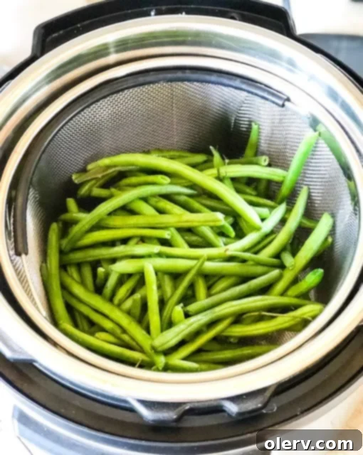 Quick Instant Pot Garlic Green Beans 3 Close-up of freshly cooked Instant Pot Garlic Green Beans in a serving bowl, glistening with butter