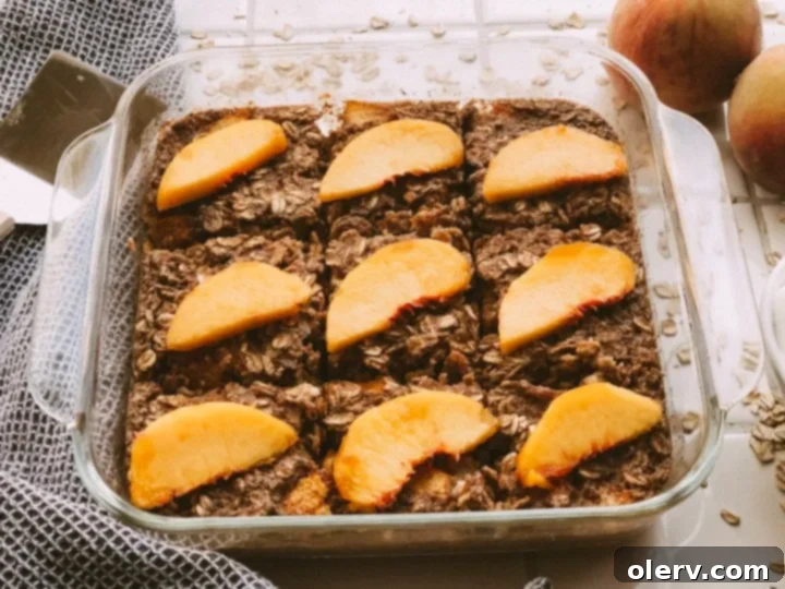Sweet Peach Baked Oatmeal 3 Close-up of peach baked oatmeal with fresh peach slices and a hint of Greek yogurt