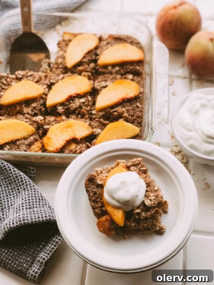 Sweet Peach Baked Oatmeal 4 Baked oatmeal with peach slices on top in a square baking dish, fresh out of the oven