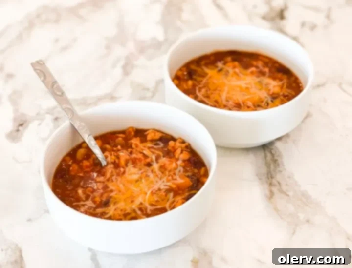 Hearty, Healthy Turkey Chili 2 A steaming bowl of healthy turkey chili, garnished with a dollop of sour cream and fresh cilantro.