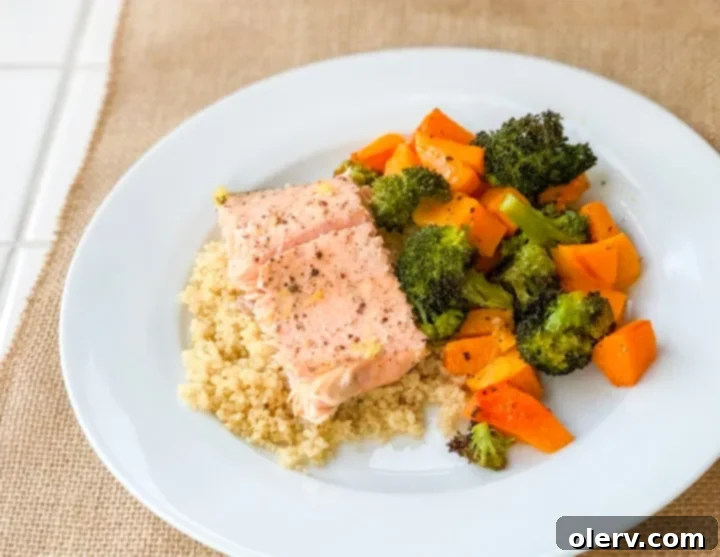 Savory Baked Salmon, Roasted Butternut Squash, and Broccoli 6 A close-up of sheet pan with roasted butternut squash, broccoli, and a perfectly baked salmon fillet.