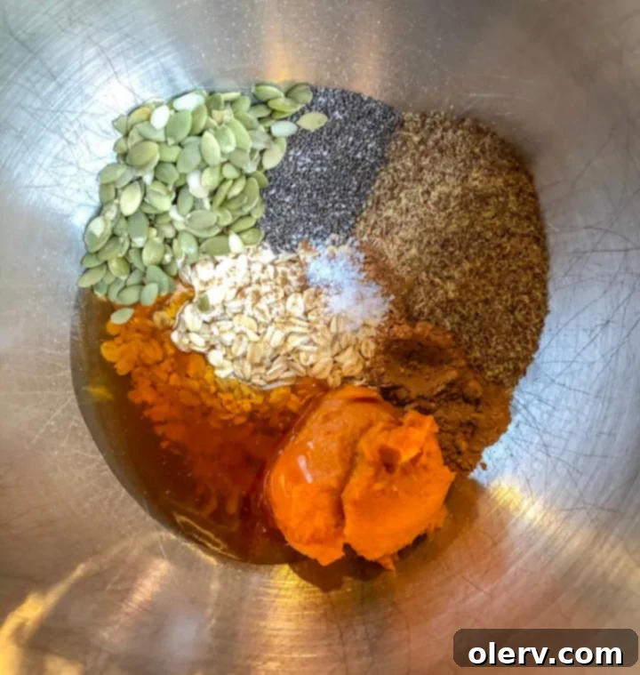 Various wholesome ingredients for Pumpkin Energy Bites neatly arranged on a rustic wooden surface
