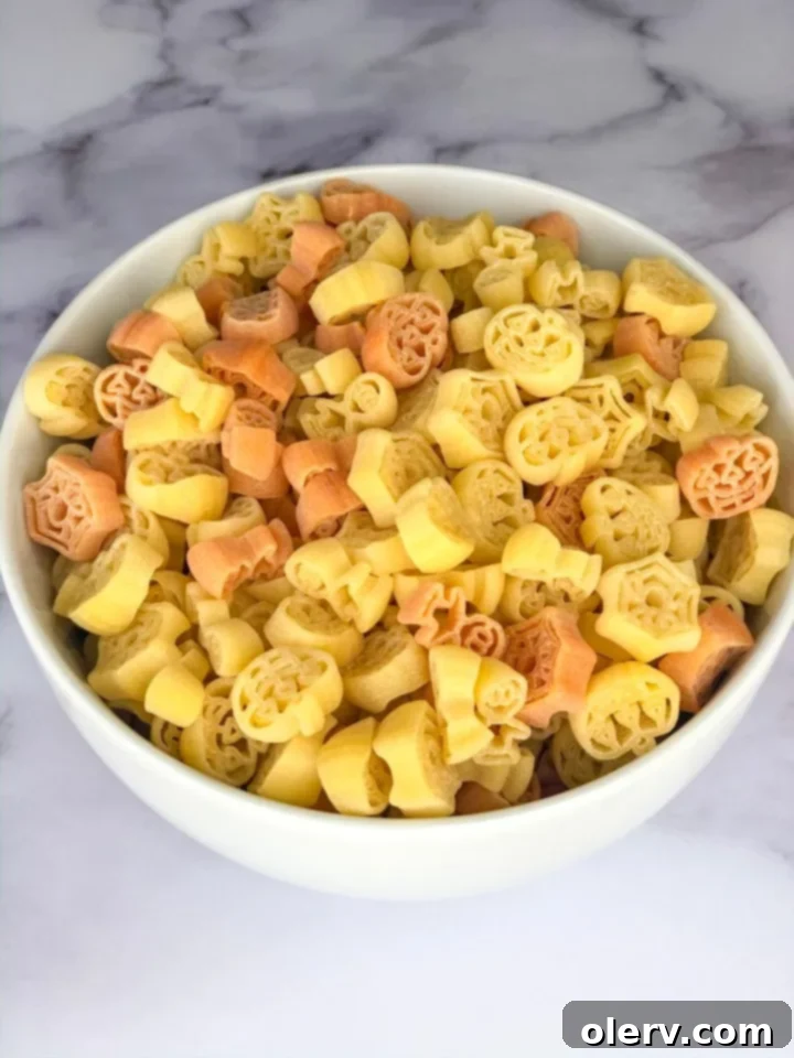 Autumn Pumpkin Macaroni Bake 4 A dish of Spiced Pumpkin Mac and Cheese served with fun, festive pumpkin-shaped pasta, highlighting the seasonal theme.