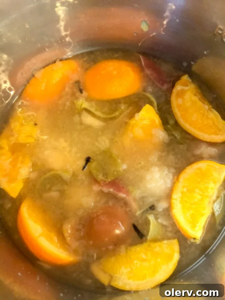 Instant Pot Holiday Magic 14 Cooked fruit being mashed inside the Instant Pot for apple cider.