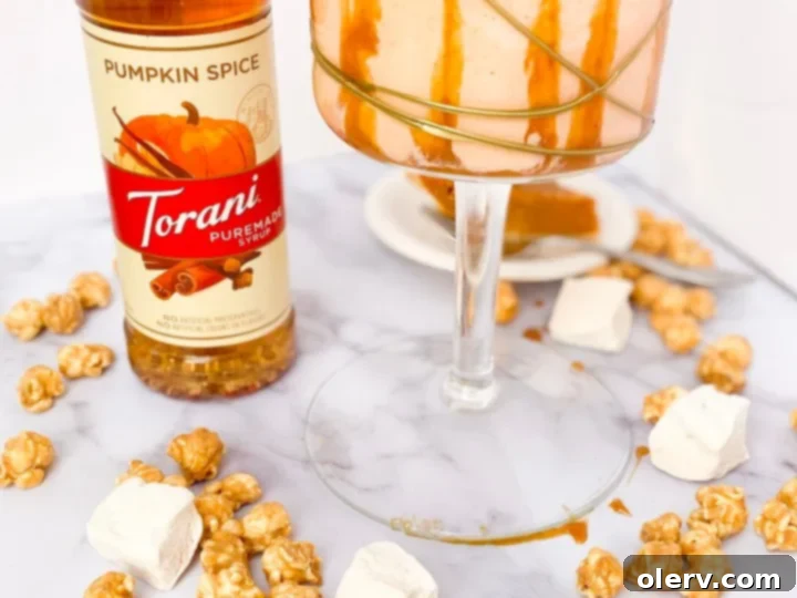 Decadent Caramel Pumpkin Pie Shake 6 Ingredients for a Caramel Pumpkin Pie Shake including Torani syrup and pumpkin pie slice