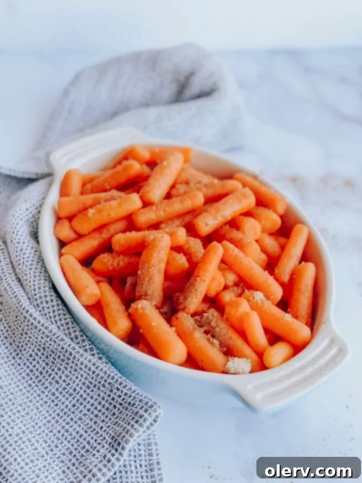 Sweet Glazed Instant Pot Carrots 3 Overhead shot of Instant Pot Glazed Carrots in a bowl, with a serving spoon.