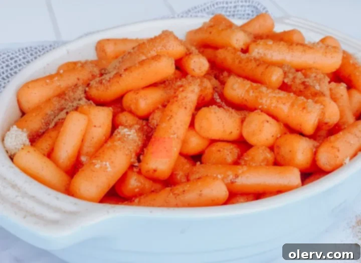Sweet Glazed Instant Pot Carrots 4 Raw baby carrots, ready for cooking, displayed on a wooden cutting board.