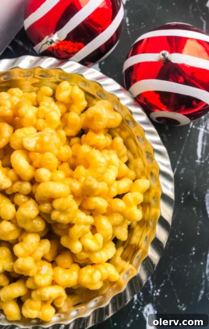 Effortless Caramel Puff Popcorn Delight 5 Caramel puff popcorn cooling on parchment paper