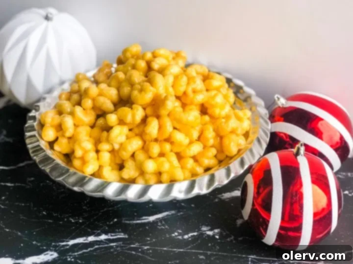 Effortless Caramel Puff Popcorn Delight 6 A bowl of caramel puff popcorn with hands reaching for it