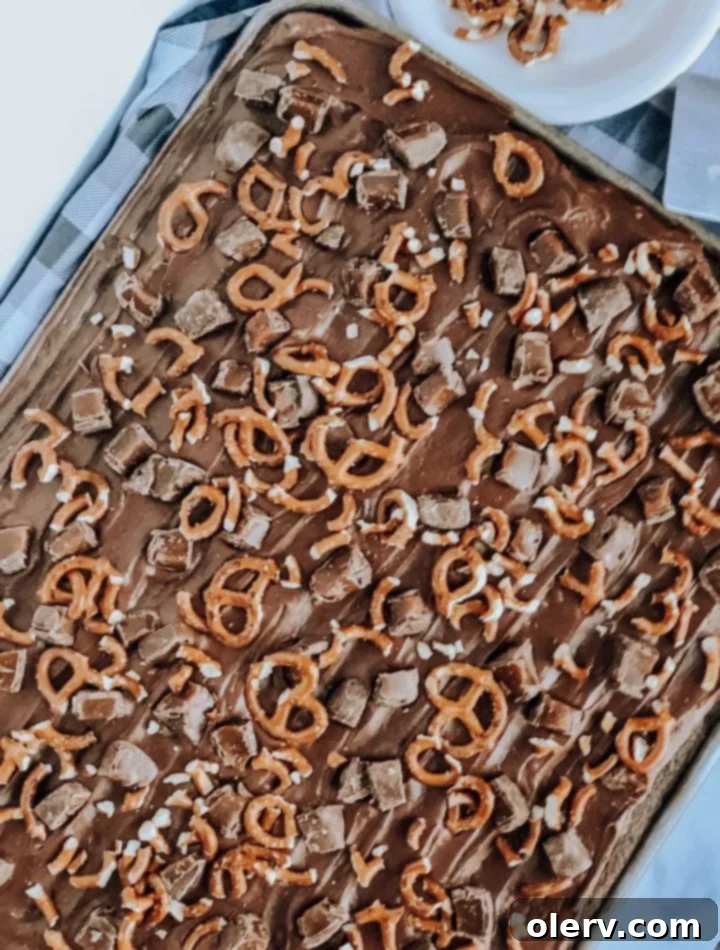 Irresistible Salted Caramel Pretzel Brownies 6 Close-up of Salted Caramel Pretzel Brownies being frosted with chocolate buttercream