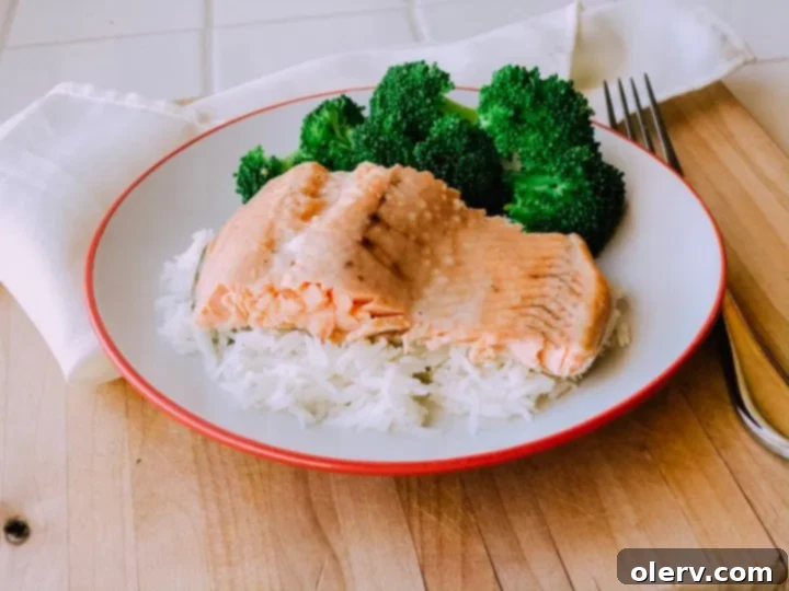Golden Honey Garlic Glazed Salmon 4 Fresh salmon fillets with lemon slices and herbs, ready for cooking