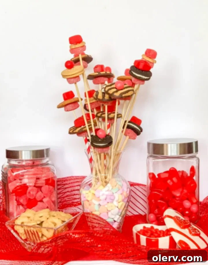 Valentine's Sweetest Blooms 2 A vibrant Valentine's Candy Flower Bouquet overflowing with a variety of candies and cookies arranged like flowers in a vase filled with conversation hearts.
