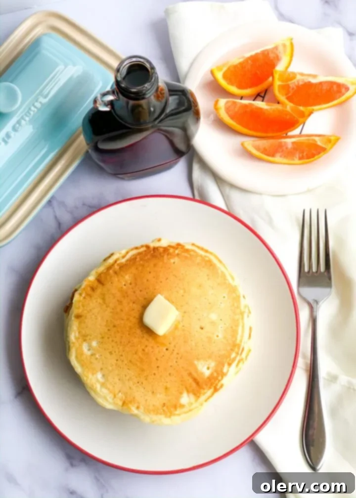 Effortless Overnight Sourdough Pancakes 5 Mixing sourdough pancake batter in a glass bowl