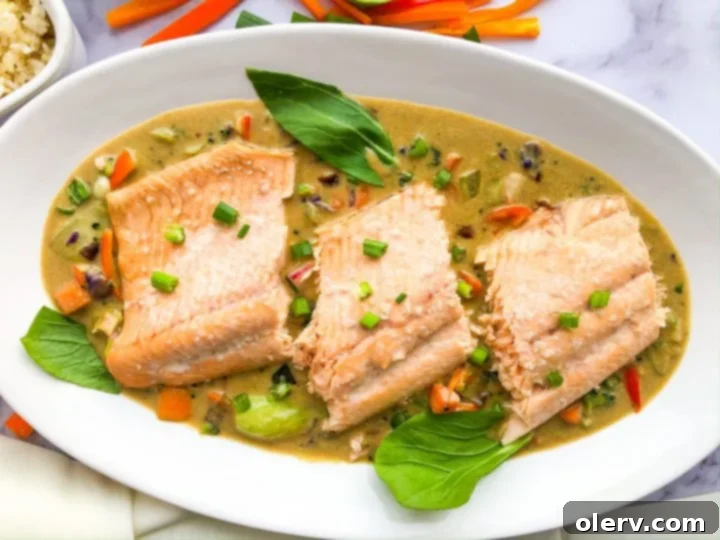 Coconut Green Curry Salmon 8 A bowl of Coconut Green Curry Salmon with a side of rice.