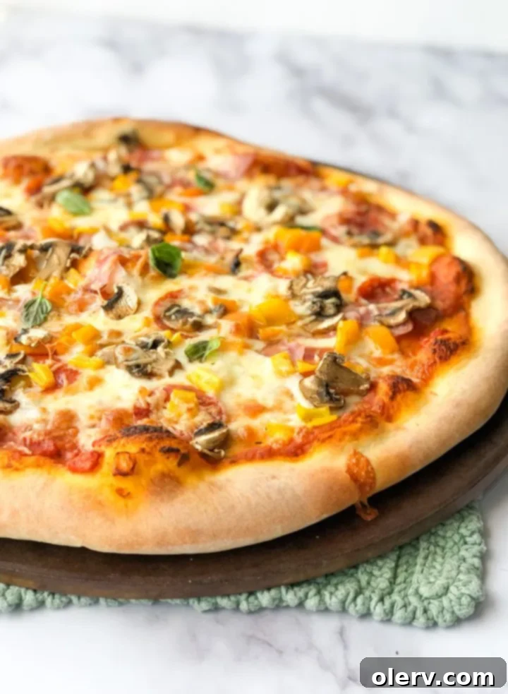 Effortless Sourdough Pizza Dough 5 A freshly baked sourdough pizza, ready to be sliced