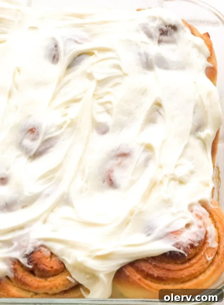 Irresistible Cream Cheese Frosted Cinnamon Rolls 6 Top view of freshly frosted cinnamon rolls in a baking pan