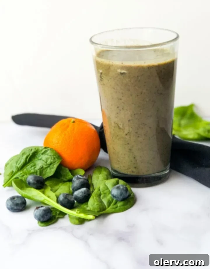 Nature's Immunity Elixir 5 Someone holding a glass of green smoothie, with a vibrant green color.
