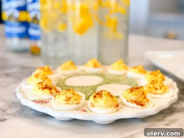 Instant Pot's Secret to Perfect Deviled Eggs 2 Perfectly prepared deviled eggs on a white plate, garnished with paprika and ready to be served as an appetizer.