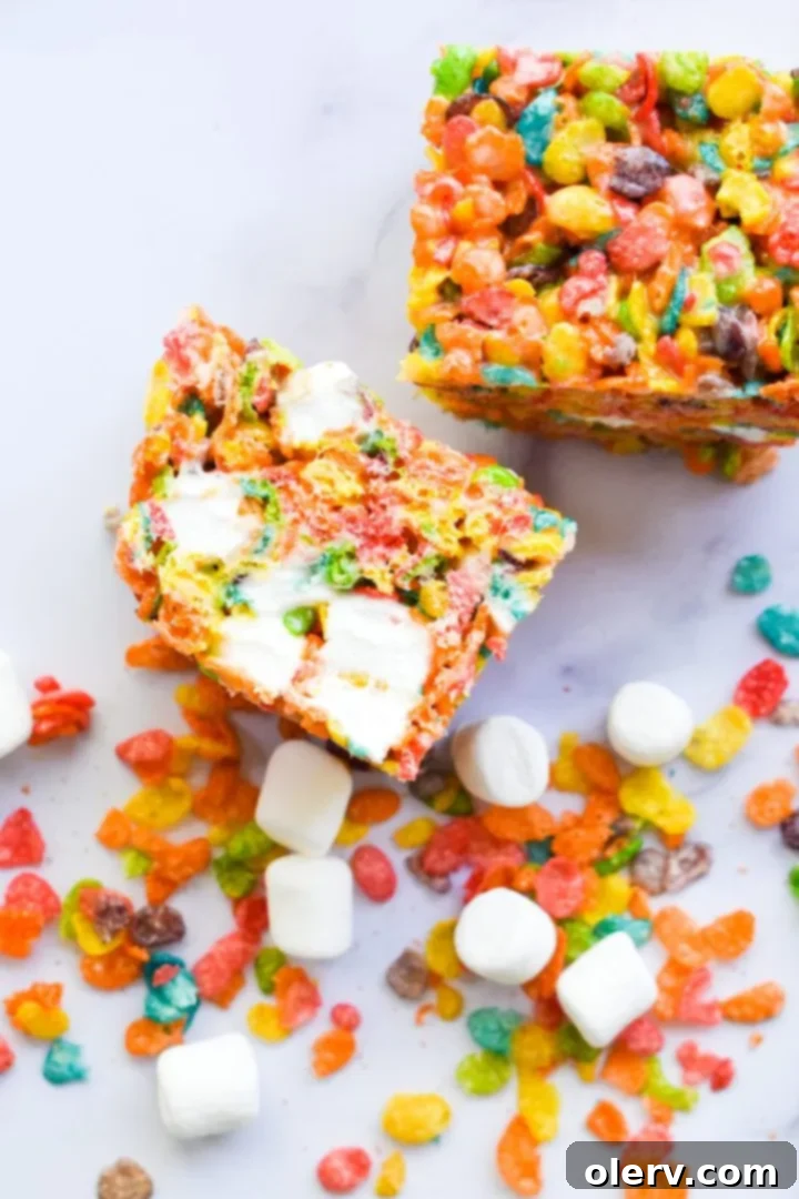 Ultimate Fruity Pebbles Bars 3 Close-up of a single Fruity Pebbles Cereal Bar, showing the intricate mix of colorful cereal and melted marshmallows.