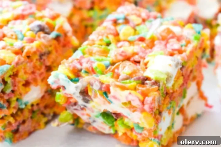 Ultimate Fruity Pebbles Bars 7 The melted marshmallow mixture being poured over a bowl of Fruity Pebbles cereal.