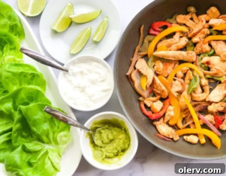 Low-Carb Chicken Fajita Lettuce Wraps 5 A close-up shot of the cooked chicken and bell pepper filling in a skillet.