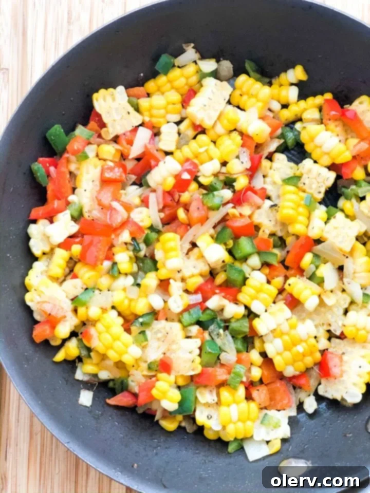 Spicy Jalapeño Corn 7 A serving of freshly prepared Jalapeño Fried Corn in a bowl, with a spoon