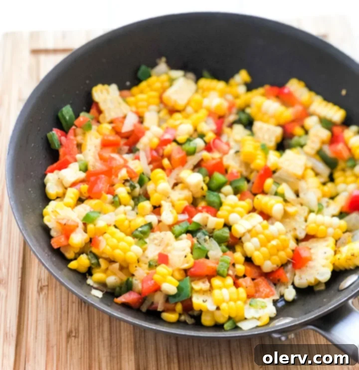Spicy Jalapeño Corn 8 Jalapeño Fried Corn served in a white bowl with a spoon