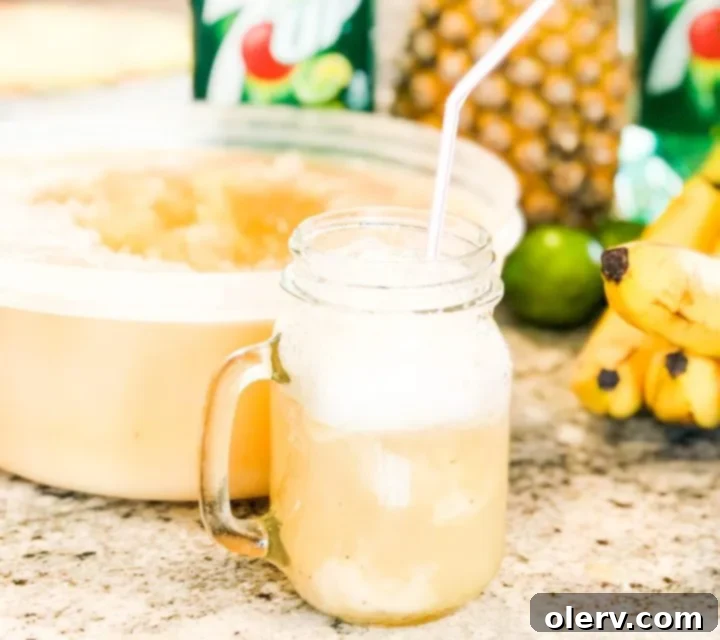 Frozen Banana Delight 2 Refreshing glass of Frozen Banana Slush with a lemon-lime soda topping, perfect for summer.