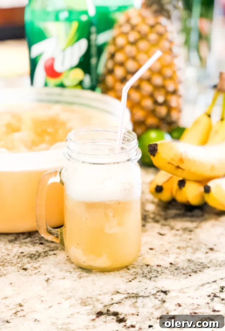 Frozen Banana Delight 12 Scooped Frozen Banana Slush with a bubbly lemon-lime soda topping in a tall glass.