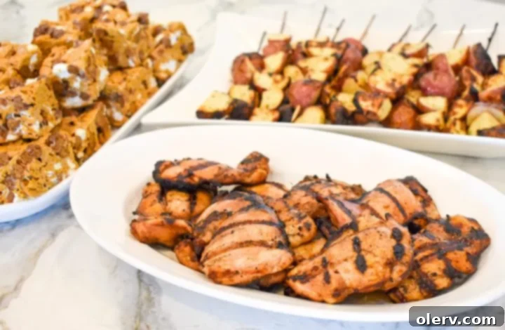 3 Deliciously Easy Memorial Day Weekend Dishes 2 A vibrant table setting for Memorial Day, featuring grilled chicken, potatoes, and s'mores bars.