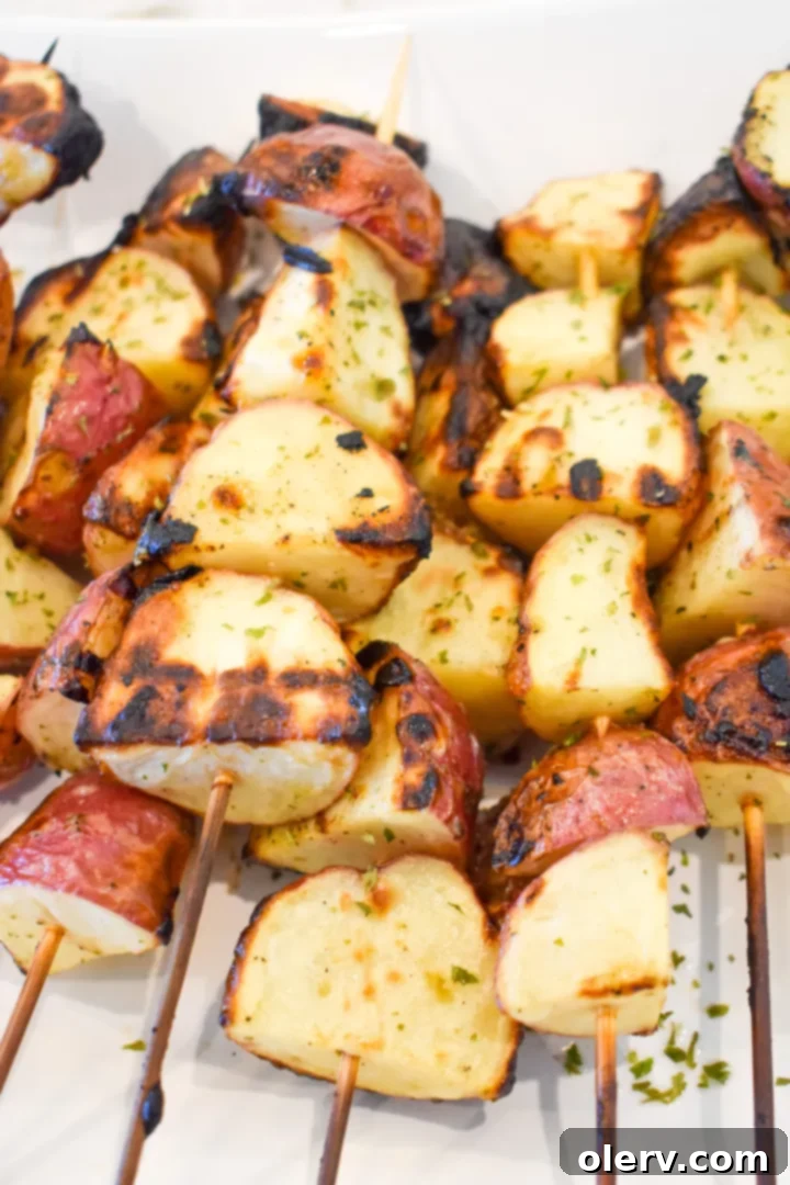 Grilled ranch potatoes on a platter, garnished with fresh parsley.