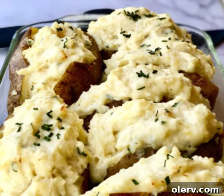 Twice-Baked Sour Cream and Chive Potatoes 5 Mashed potato filling with sour cream and chives being spooned back into potato skins
